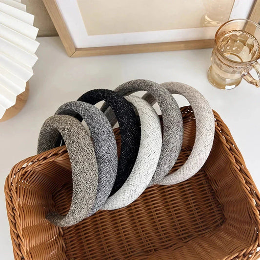 A stylish wide hairband in a classic plaid pattern, offering a chic and sophisticated look for British women.