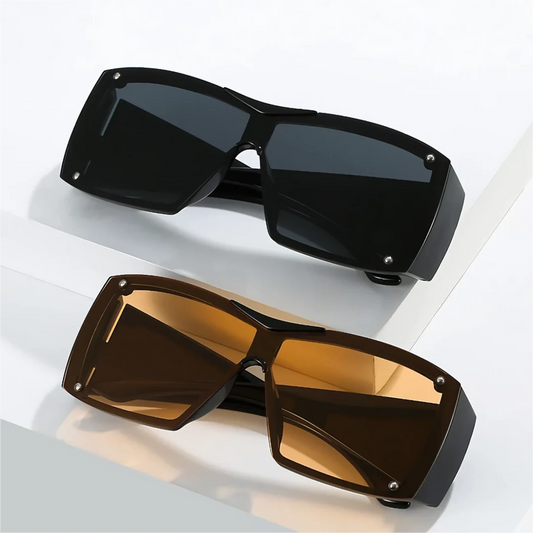 Oversized square sunglasses with black lenses and a durable plastic frame, offering UV400 protection and adaptive photochromic technology.