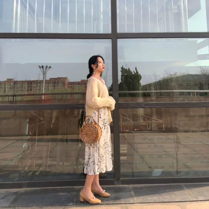 Elegant handcrafted rattan basket handbag with floral design, showcasing traditional British craftsmanship and modern sophistication