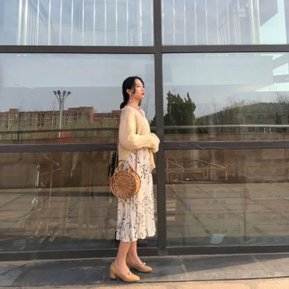 Elegant handcrafted rattan basket handbag with floral design, showcasing traditional British craftsmanship and modern sophistication