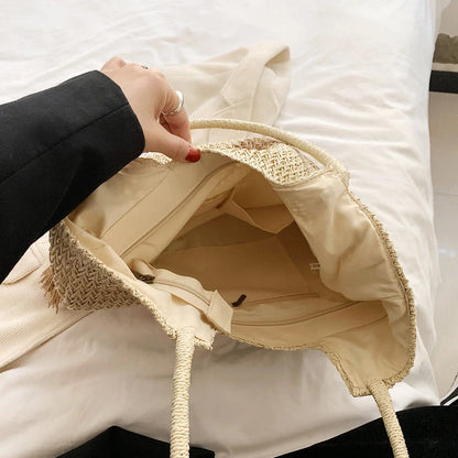 Stylish bohemian-inspired woven tote bag with contrasting tassels, perfect for summer outings