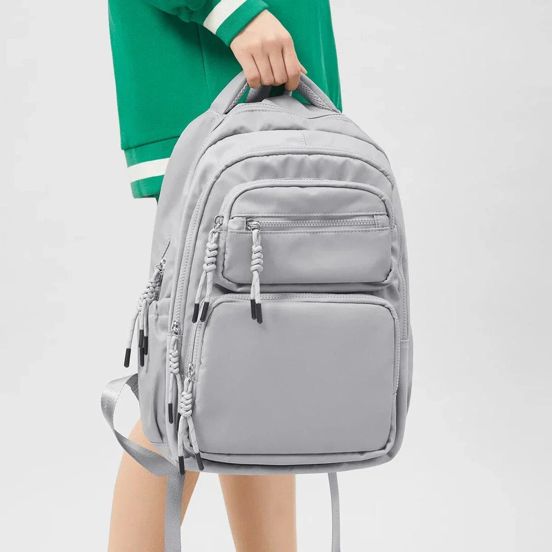 Premium leather backpack with dedicated laptop compartment, soft handles, and arcuate shoulder straps for modern women