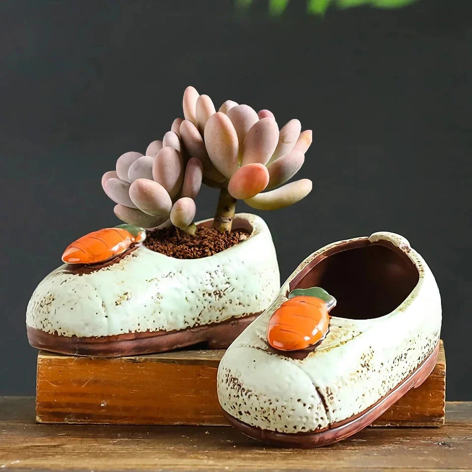 Charming ceramic boot-shaped vase with a glazed finish, perfect for displaying succulents and flowers in your home or garden