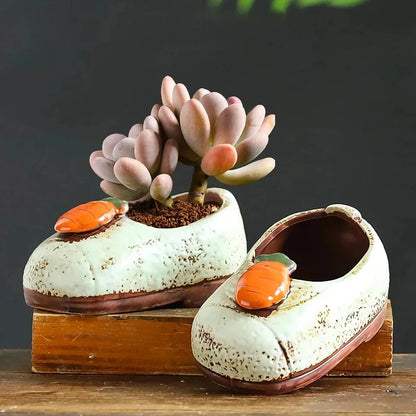 Charming ceramic boot-shaped vase with a glazed finish, perfect for displaying succulents and flowers in your home or garden