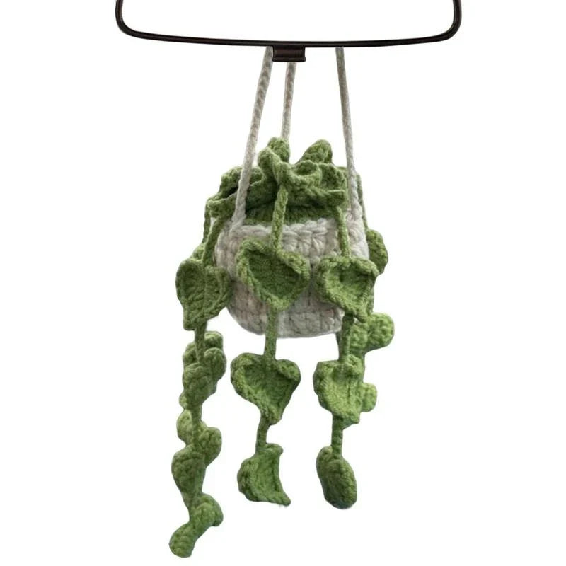 Charming knitted car plant decor with hanging white rope and green and white colour scheme