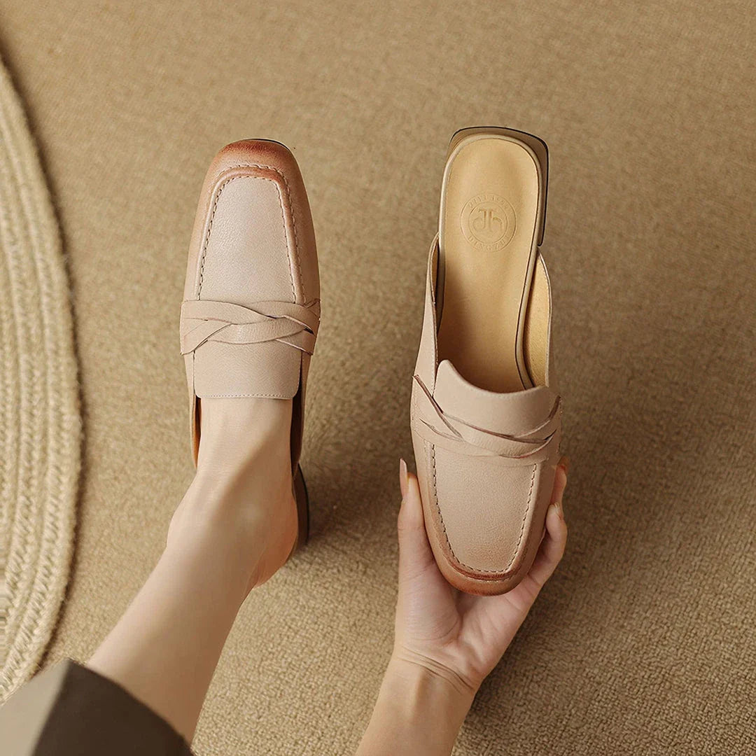 Stylish leather mules in a khaki colour, featuring a low square heel and a sleek, shallow-cut design for a retro-inspired, sophisticated look.