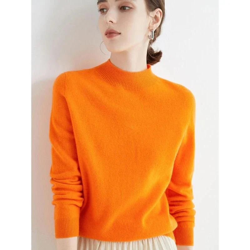 A woman wearing a luxurious Merino wool mock-neck jumper in a stylish autumnal outfit
