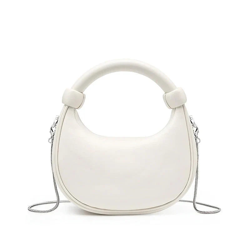 Elegant rose pink leather crescent-shaped crossbody bag with adjustable strap and zipper closure