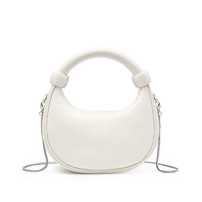 Elegant rose pink leather crescent-shaped crossbody bag with adjustable strap and zipper closure