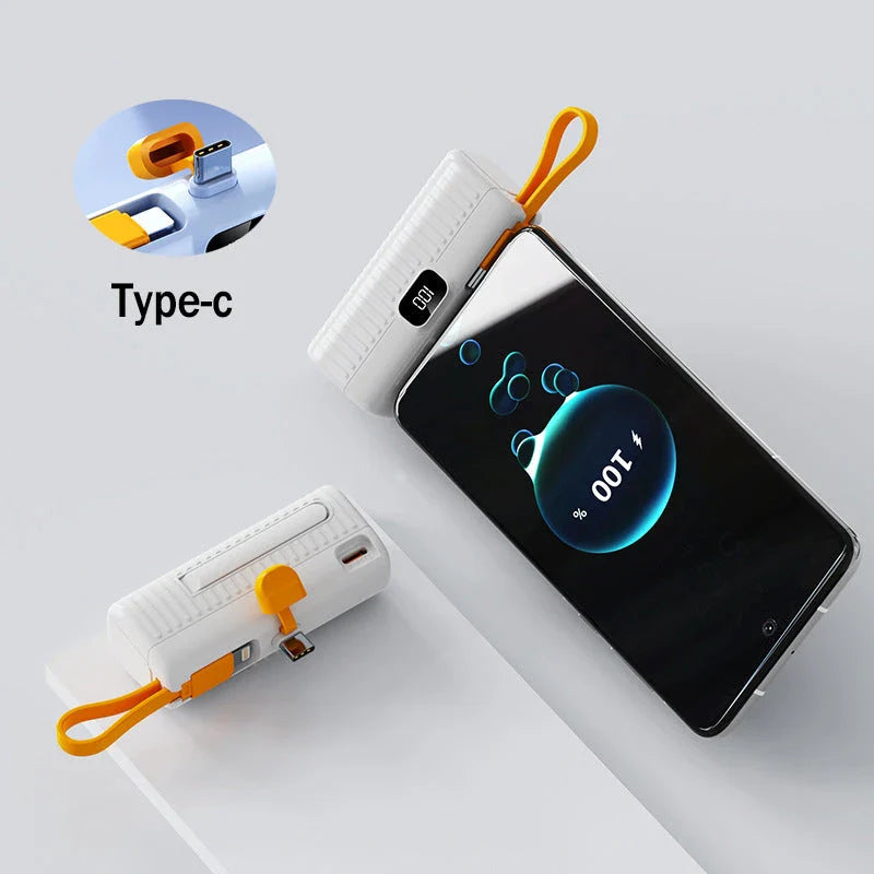 Compact, high-capacity power bank with dual charging ports and built-in cables for convenient, fast charging on the go