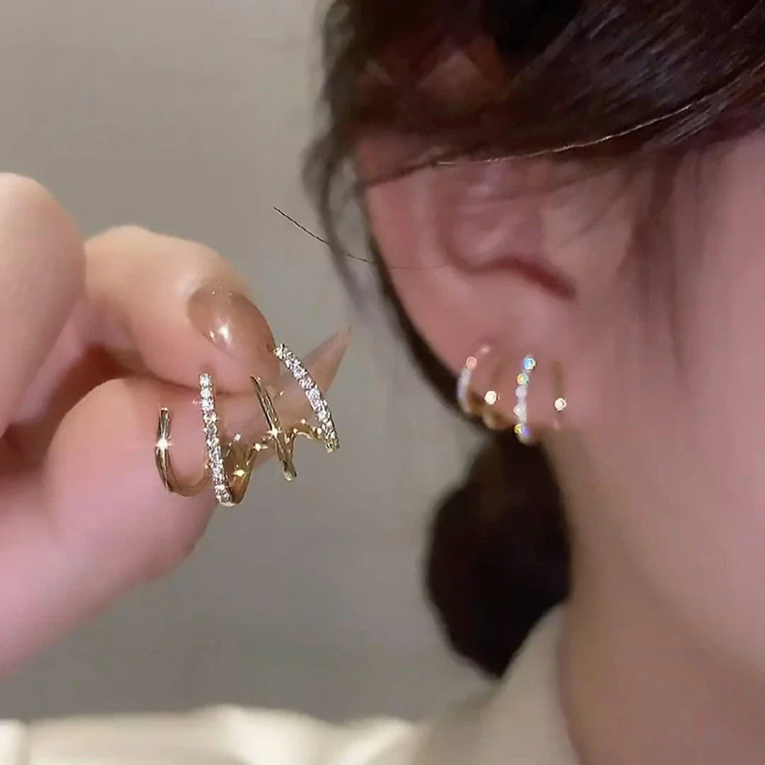 Exquisite zircon four-claw stud earrings in a gleaming gold colour, showcasing a timeless and elegant design