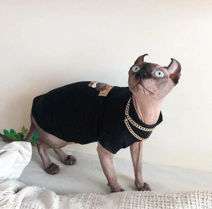 A stylish cotton sweater with a vibrant printed design and a coordinating necklace accessory, perfect for keeping your cat warm and fashionable.
