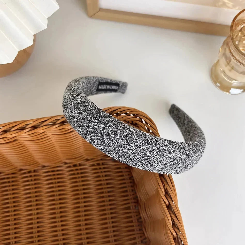 A stylish wide hairband in a classic plaid pattern, offering a chic and sophisticated look for British women.