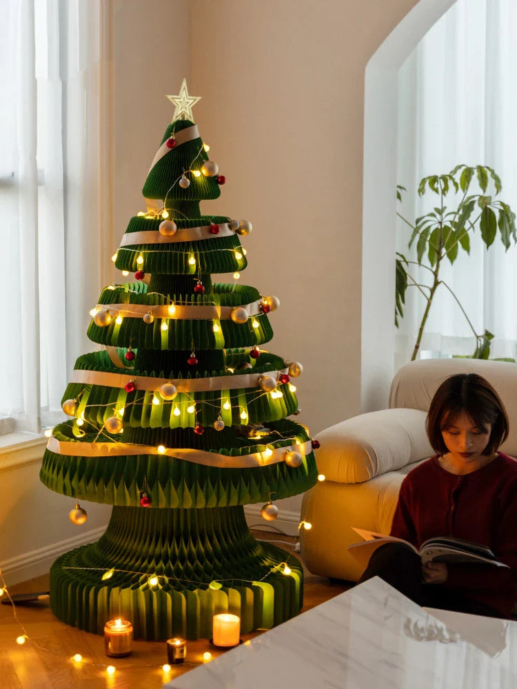A beautifully crafted origami Christmas tree decoration in a Nordic-inspired style, with a warm, glowing illumination