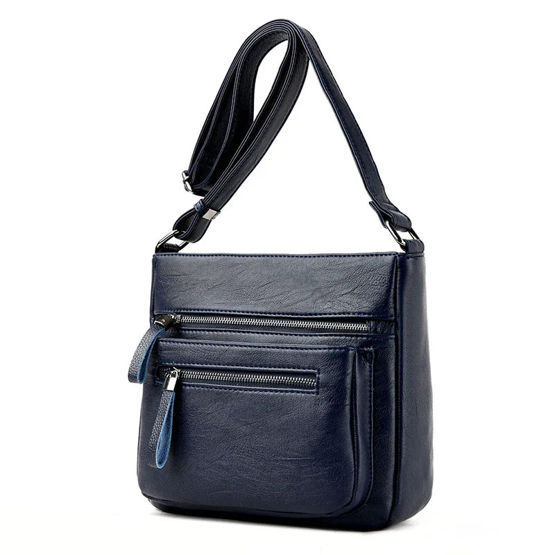 A stylish leather shoulder bag in a modern, box-style design, perfect for busy modern mums.