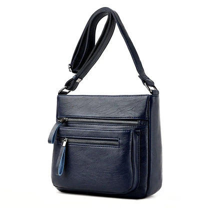 A stylish leather shoulder bag in a modern, box-style design, perfect for busy modern mums.