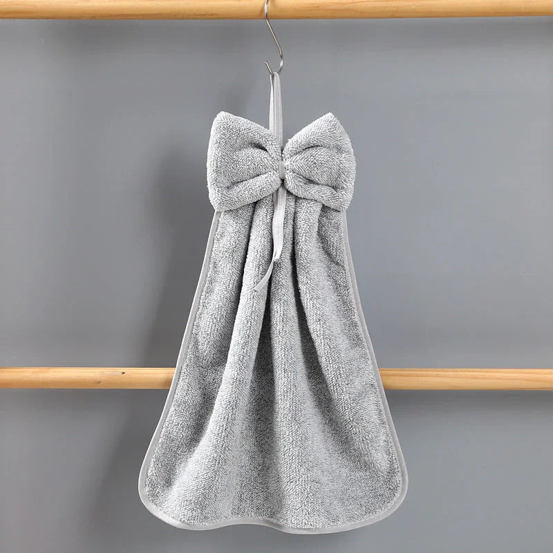 Elegant coral fleece hand towels with a unique bow design, perfect for kitchen and bathroom use
