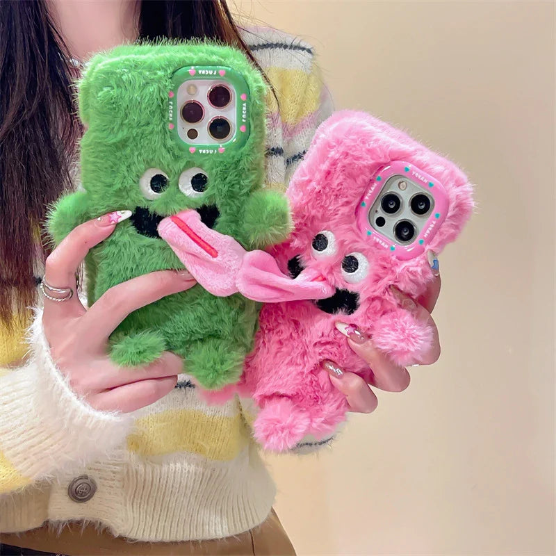 Playful plush phone case with cheeky cartoon monster in pink or green, offering shock-absorbing protection for iPhone models