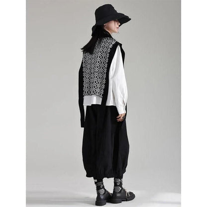 Women's black sleeveless vest with irregular knitting pattern, a versatile and stylish layering piece for the modern British woman