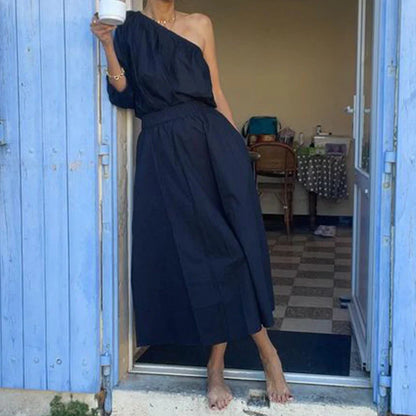 Elegant two-piece mid-length skirt suit with oblique shoulder design, made with premium polyester fabric and boutique four-sided elastic band