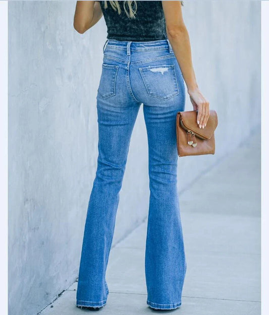 Premium distressed denim trousers for British women, featuring a high-waist silhouette and subtle ripped detailing