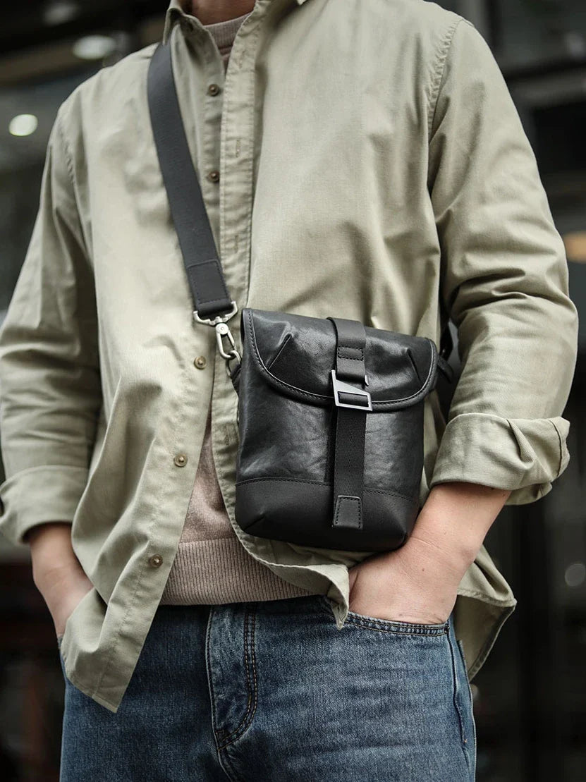 Premium cowhide leather shoulder sling bag with one-shoulder design and oblique paneling for modern British style
