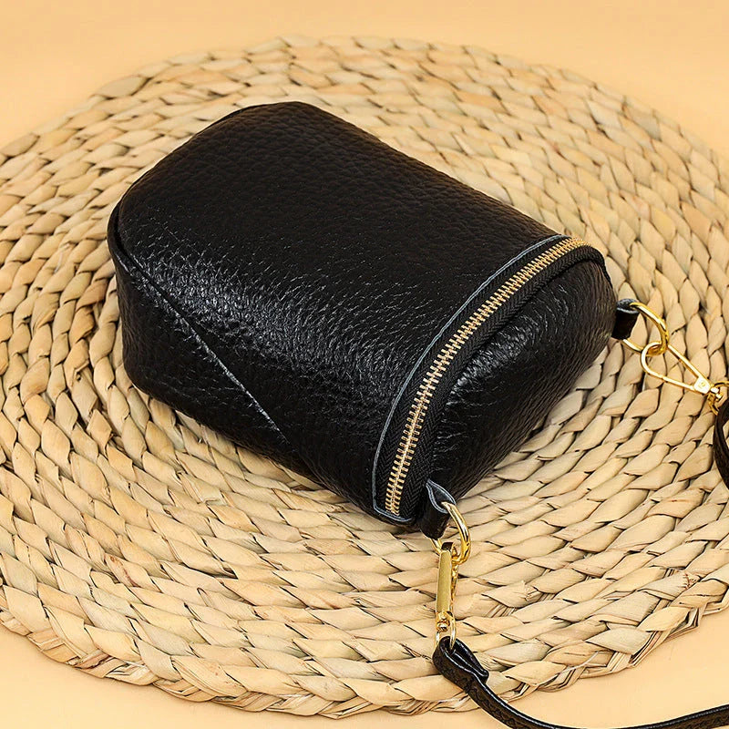 Elegant leather crossbody bag with adjustable strap, multiple pockets, and premium cowhide construction for the modern British woman