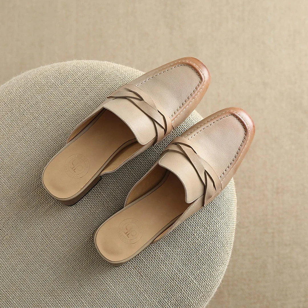 Stylish leather mules in a khaki colour, featuring a low square heel and a sleek, shallow-cut design for a retro-inspired, sophisticated look.