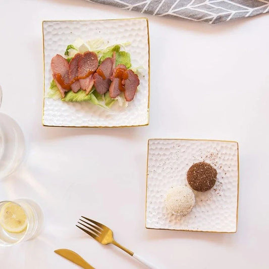 Elegant embossed ceramic cake plate in white, perfect for serving desserts and platters.