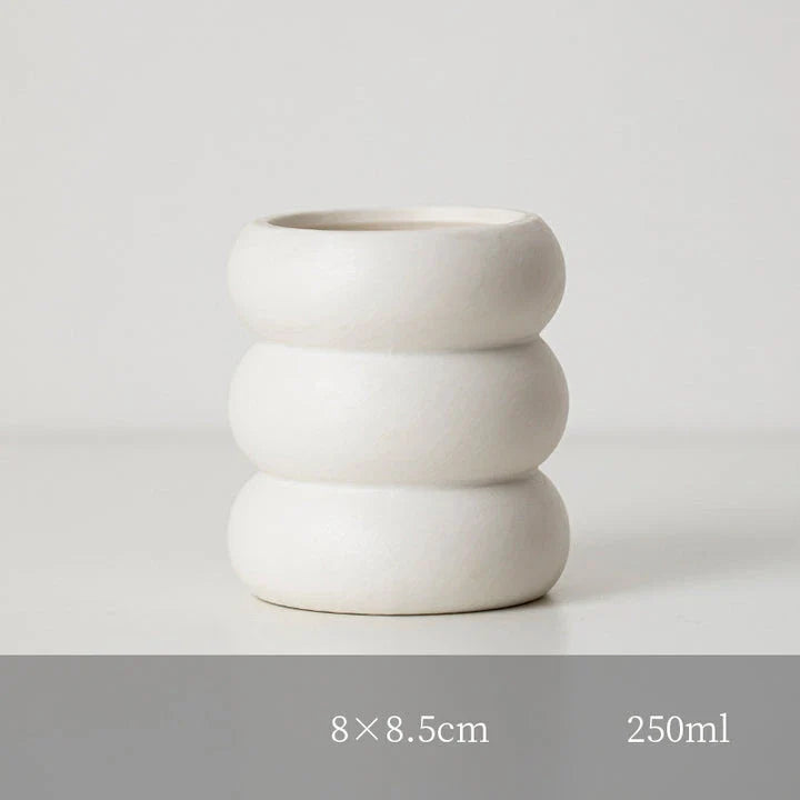 A white ceramic candlestick holder with a minimalist Nordic design, perfect for creating a cosy and sophisticated ambience in any room.