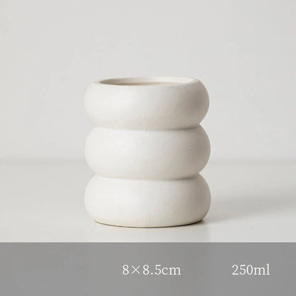 A white ceramic candlestick holder with a minimalist Nordic design, perfect for creating a cosy and sophisticated ambience in any room.