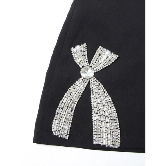 Chic shawl collar blazer and skirt set for women, featuring a sophisticated design with a diamond bow detail and full-length sleeves for a refined look.