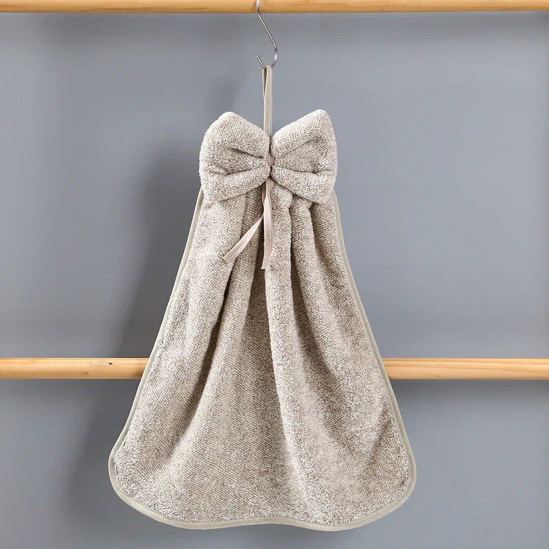 Elegant coral fleece hand towels with a unique bow design, perfect for kitchen and bathroom use