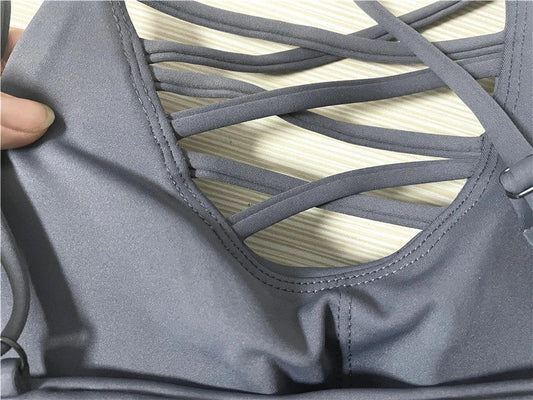 A 3-piece sports set including a hooded top, sports bra, and high-waisted leggings in a black colour scheme.