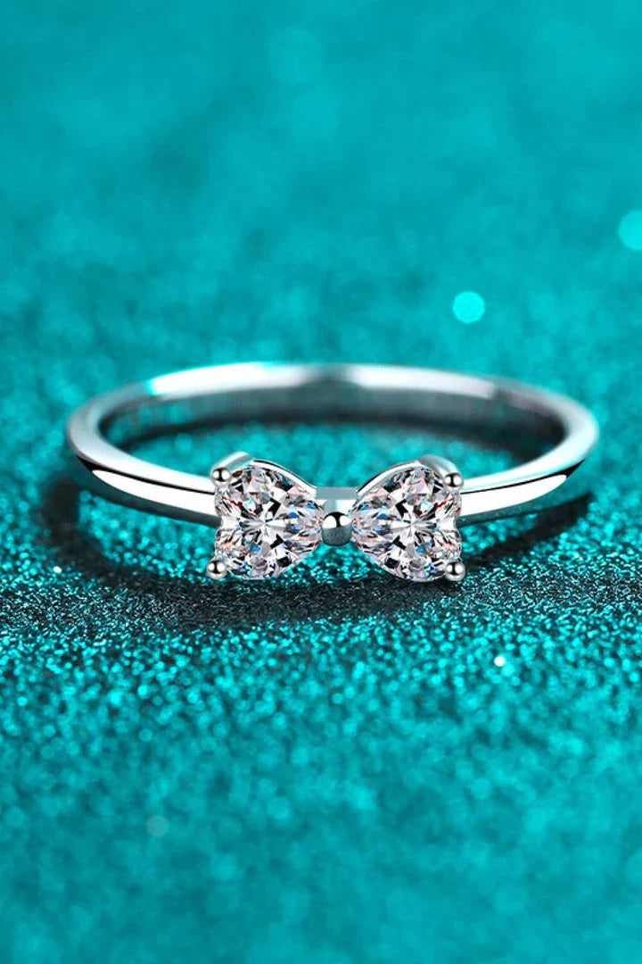 Elegant moissanite and sterling silver bow ring with a radiant, polished finish