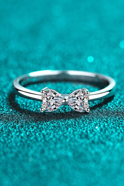 Elegant moissanite and sterling silver bow ring with a radiant, polished finish