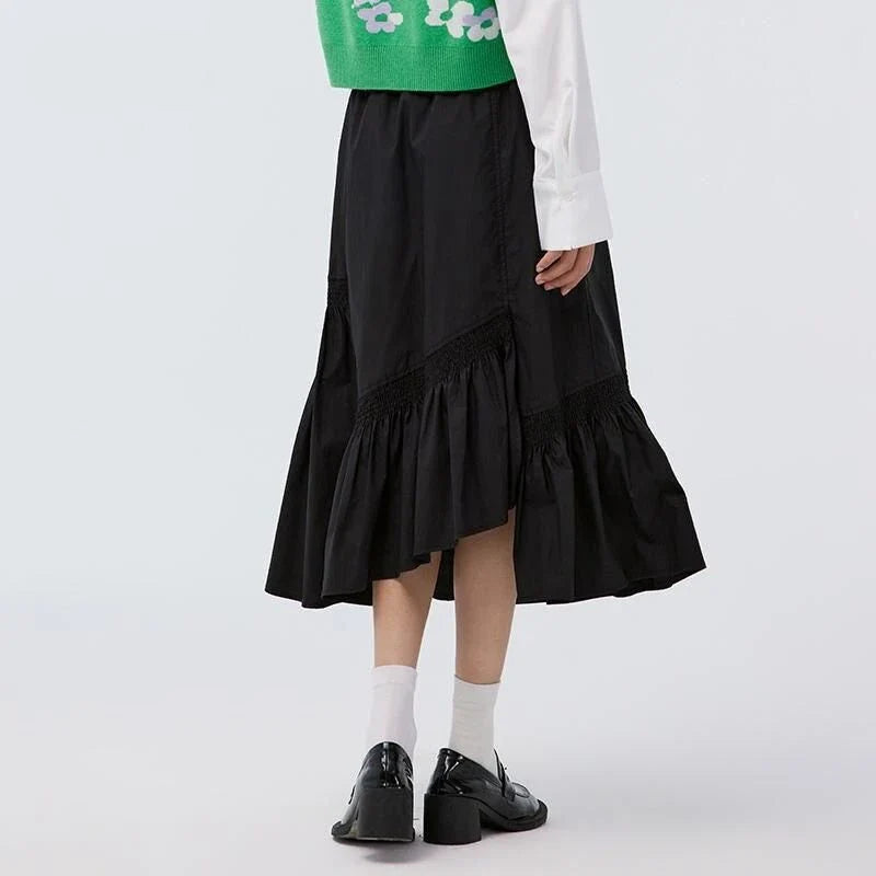Elegant mid-length black skirt with an A-line silhouette, natural waistline, and unique irregular hemline, perfect for the modern British woman's wardrobe