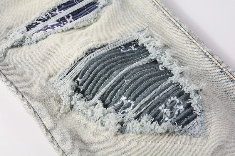 Stylish distressed denim jeans with a skinny, knee-exposed silhouette for a contemporary, high-street fashion look