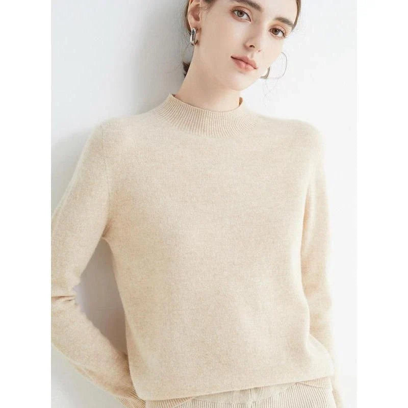 A woman wearing a luxurious Merino wool mock-neck jumper in a stylish autumnal outfit