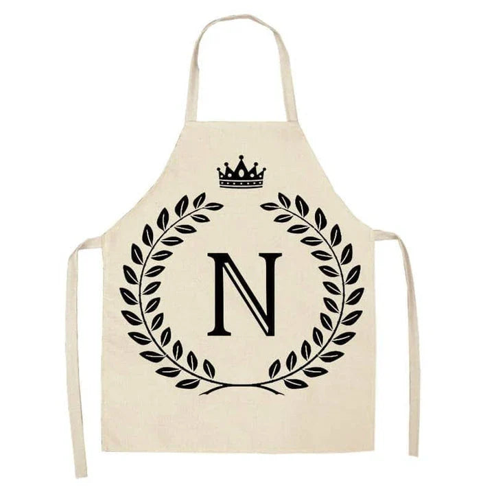A high-quality kitchen apron featuring a charming crown and letter print design in a premium cotton and linen blend fabric.