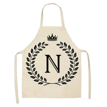 A high-quality kitchen apron featuring a charming crown and letter print design in a premium cotton and linen blend fabric.