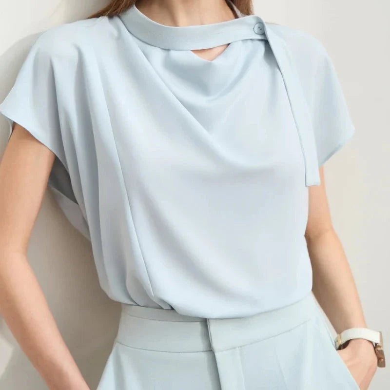 Elegant minimalist women's summer blouse in blue chiffon fabric with tie sleeves and hollow-out decoration