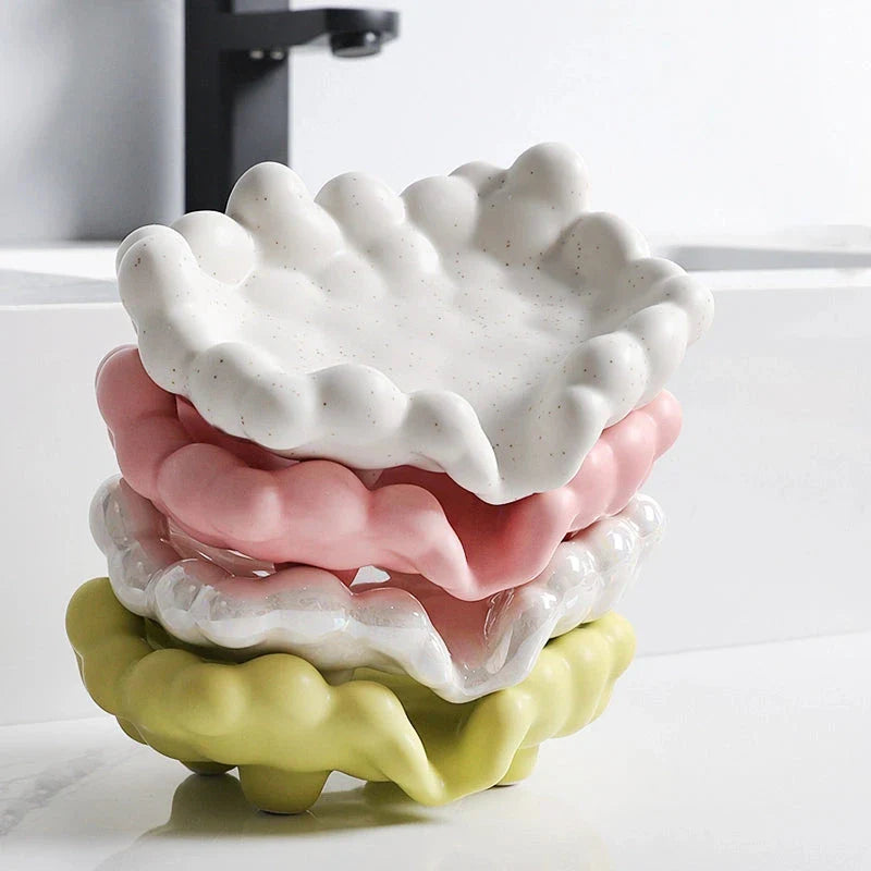 A ceramic soap dish with a whimsical cloud design, perfect for elevating your bathroom decor.