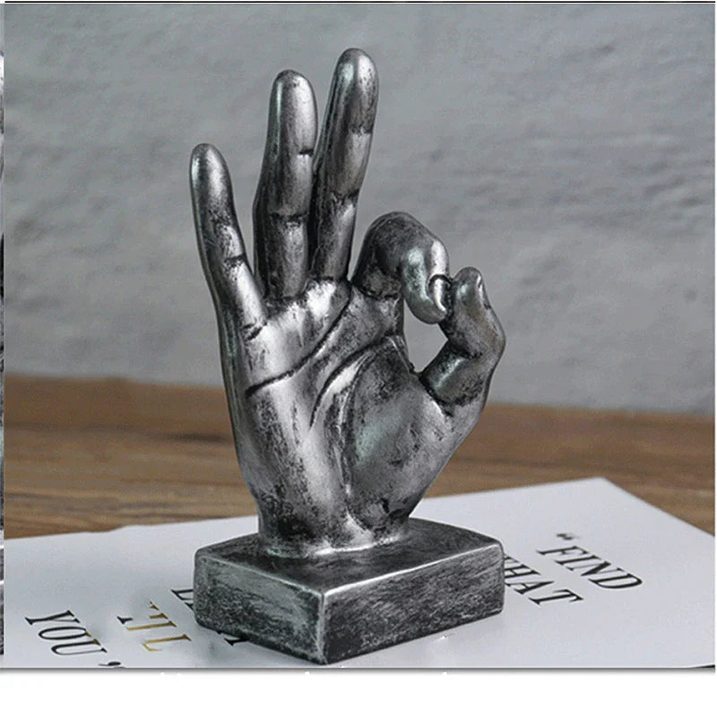 Elegant resin gesture ornaments in a variety of classic bronze and silver finishes, perfect for adding a charming accent to British-inspired home decor