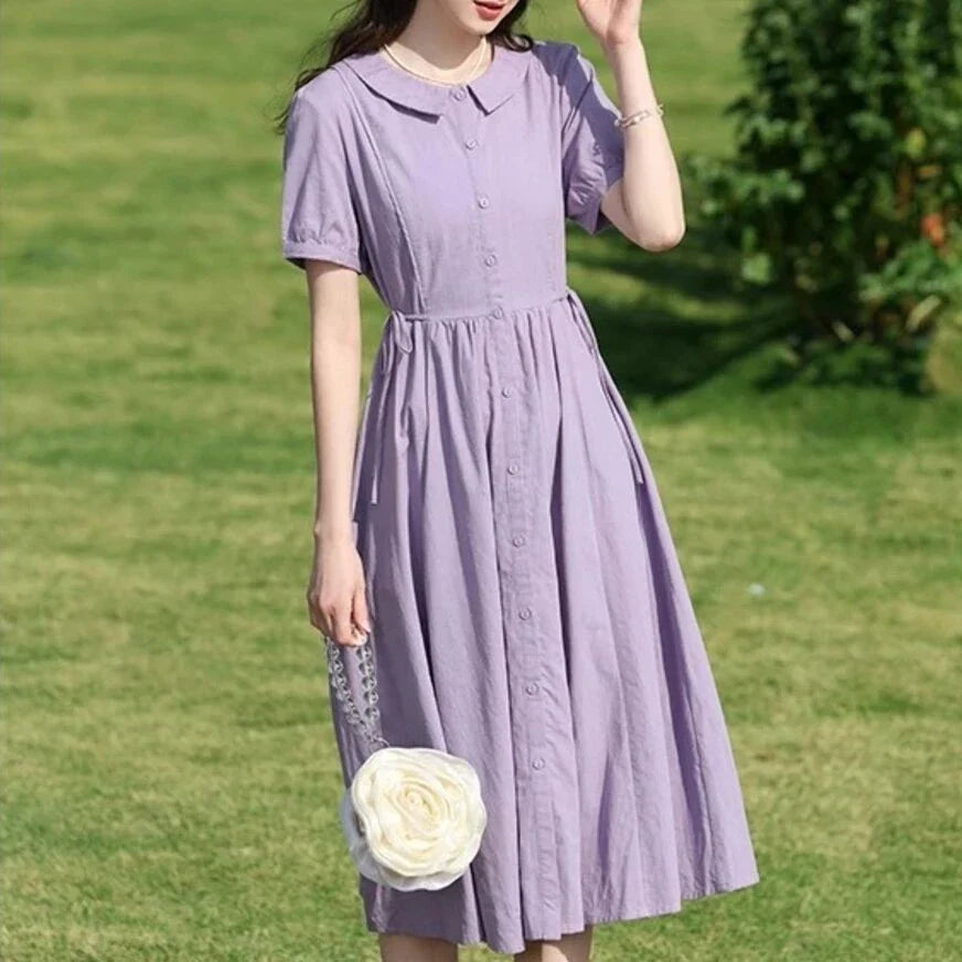 Sophisticated French-inspired short sleeve summer dress with puff sleeves, turn-down collar, and lace-up detailing