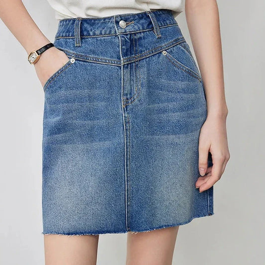Sophisticated lyocell denim mini skirt with classic A-line silhouette and functional pockets for the discerning British woman