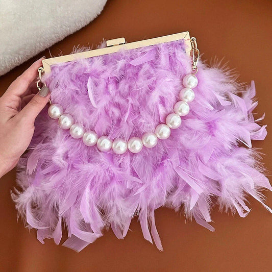 Elegant feather clutch purse with lustrous pearls, metal chains, and a top handle design