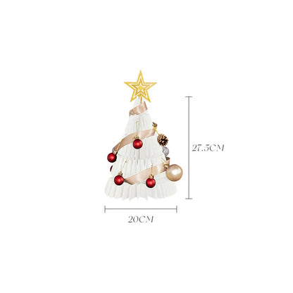A beautifully crafted origami Christmas tree decoration in a Nordic-inspired style, with a warm, glowing illumination
