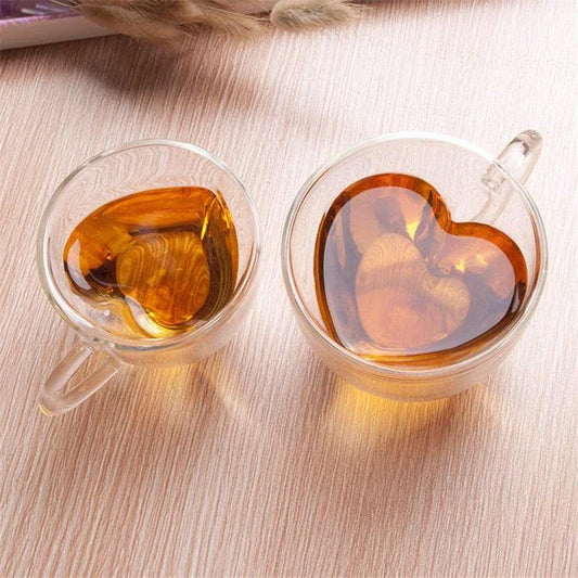 Elegant double heart-shaped ceramic mug in glass, perfect for enjoying hot beverages with a touch of British charm
