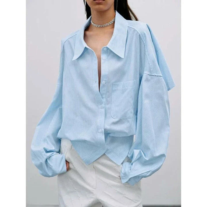 A stylish patchwork blouse with functional pockets, perfect for casual and semi-formal occasions during the autumn and winter seasons.